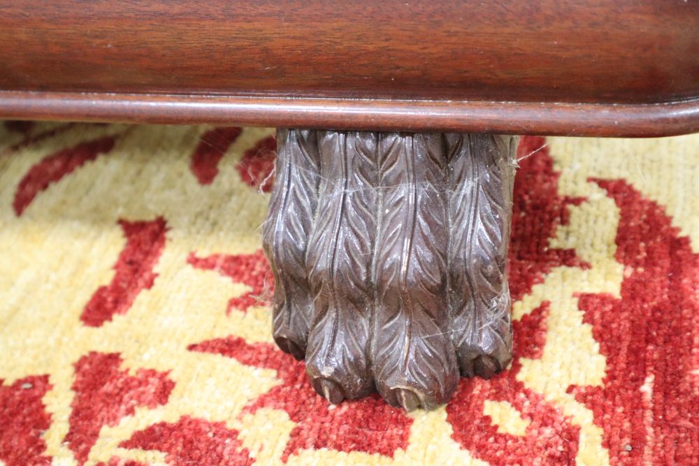 A mahogany sword stand, bow shape with reeded columns, claw feet, 92cm